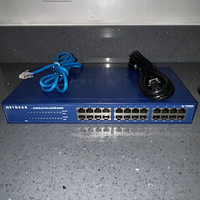 NETGEAR JFS524 PROSAFE 24 PORT 10/100 SWITCH W/ POWER CORD & CAT 5 CABLE